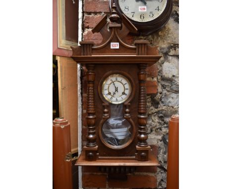 A German walnut wall clock, 73.5cm high.&nbsp; 
