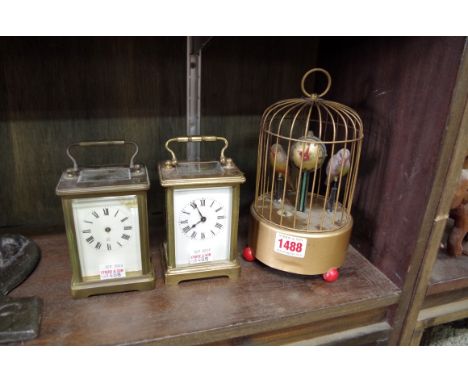 A vintage Precision Watch Co singing bird in cage clock,&nbsp;21cm high; together with two brass carriage clocks.&nbsp; 