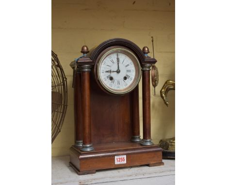 An early 20th century mahogany pillar clock,&nbsp;with 4in enamel dial, the bell striking movement with H.A.C mark, 35cm high