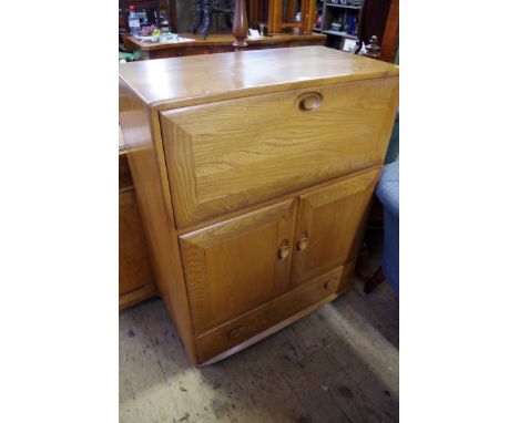 A vintage Ercol elm cabinet, labelled, 82.5cm wide. 