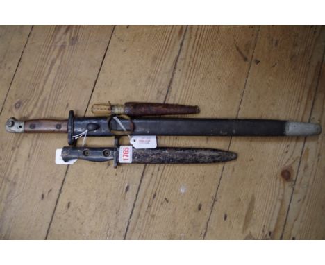 A British military L1A1 SLR knife bayonet and sheath, dated 1958; together with another British Wilkinson bayonet and scabbar