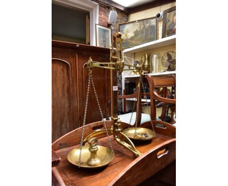 A set of brass balance scales, by Degrave &amp; Co, London, 60cm high, with a graduated set of five bell weights. 