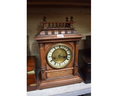 A circa 1900 German beech mantel clock, 38.5cm high, with pendulum.&nbsp; 