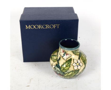 A Moorcroft Fruit Garden pattern squat vase, dated '99, height 8cm, boxedNo chips cracks or restoration, only light crazing 