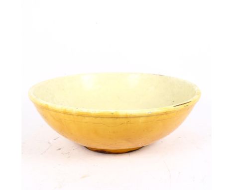 C H Brannan, a largest yellow glaze Barnstaple Pottery bowl, impressed mark on base, diameter 40cmTop rim has 1 very small su