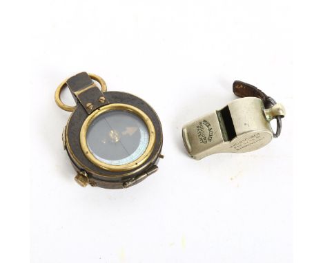 A First World War Period British military issue trench whistle, by J Hudson & Co, dated 1914, and a military issue brass comp