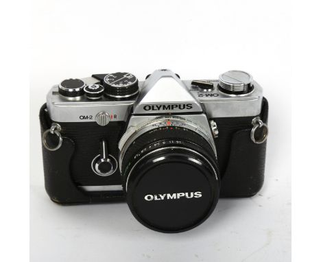 OLYMPUS - a Vintage OM-2 35mm single lens reflex camera, with Olympus 1:1,8 F=50MM lens, serial no. 126720, in Olympus softsh