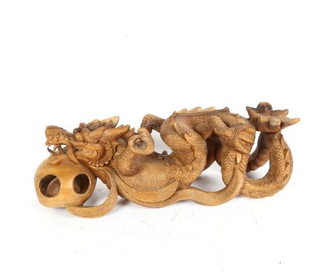 A Chinese carved hardwood dragon and pearl figure, length 48cm 
