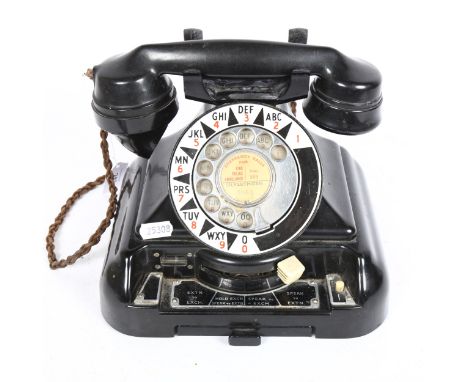 A large Vintage black Bakelite dial telephone, with enamel dial 