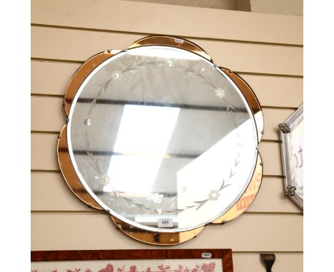 An Art Deco style peach and clear glass floral wall mirror, diameter 57cm 