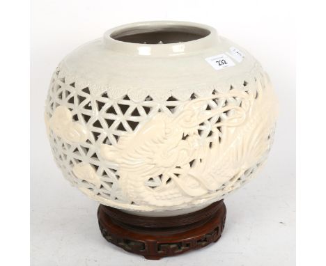 A Chinese Nan Yang ceramic lamp base, and carved hardwood stand, overall height 27cm 