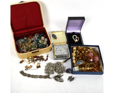A silver plated nurse's buckle, a silver leaf design brooch, unmarked yellow metal brooch with a seed pearl dove design mount
