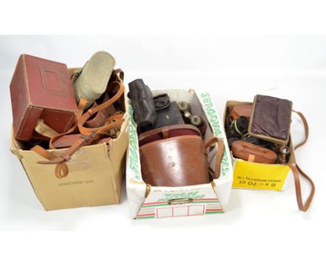 A group of binoculars of varied size and form including two military issue pairs with stamped broad arrow marks, one no.0-227