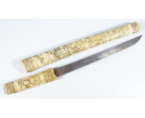 A Japanese Meiji period bone wakizashi, with carved decoration throughout, length of blade 29cm. CONDITION REPORT: PLEASE NOT