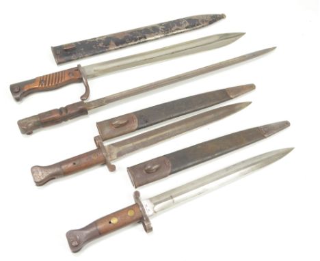 Three late 19th/early 20th century British military issue wooden handled bayonets, all with broad arrow marks and variously s