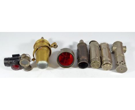 A brass Oldhall accessory security spotlight, bearing label for Liverpool, three portable candle lamps, a double lensed lamp 
