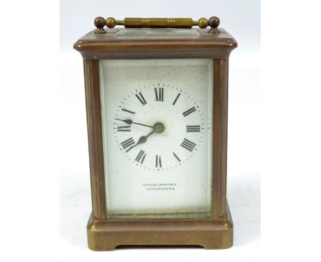 A circa 1900 French brass carriage clock with swing loop handle above rectangular white enamel dial set with Roman numerals a