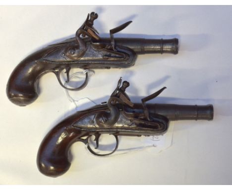A pair of small flintlock muff pistols with screw-off cannon barrels, locks inscribed 'R. Willoughby', steel furniture and wa
