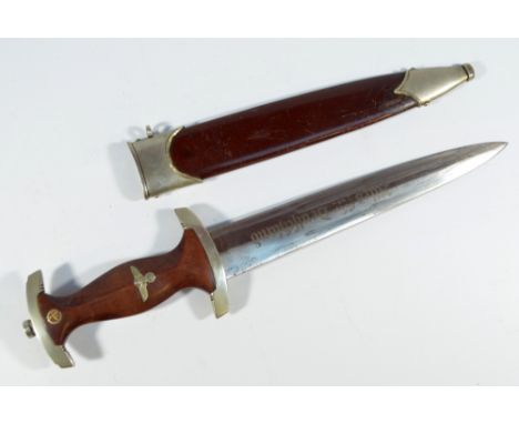 A WWII period German Third Reich SA dagger, with inset insignia to the brown wooden handle, and with Neptun of Solingen blade