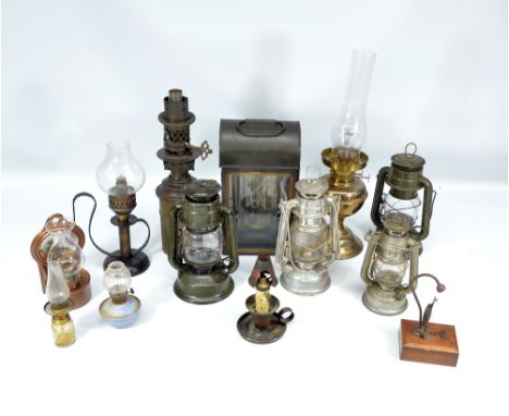 A collection of various storm lamps, oil lamp sections, etc.