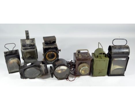 Eight various vintage lamps including an electric signalling daylight lamp by Lucas, with plaque dated 1918, a green example 