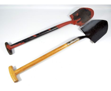 Two 20th century iron bladed spades to include a Spear & Jackson military issue example, the upper haft stamped with broad ar