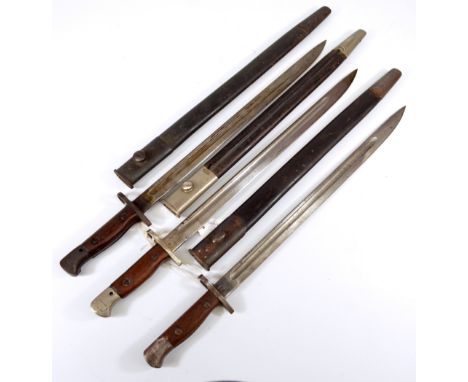 Three military issue wooden and steel handled bayonets, each with broad arrow and War Department stamps and with leather meta