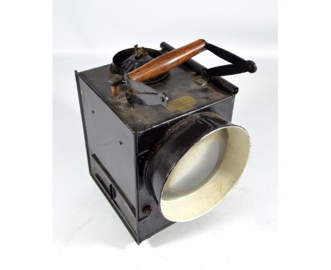 SIEMENS BROS & CO LTD OF LONDON; a large black painted lamp with hinged wooden and wrought iron handle, brass plaque stamped 