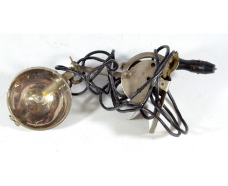 A WWII period cockpit lamp with clip bracket and domed cover on adjustable arm.