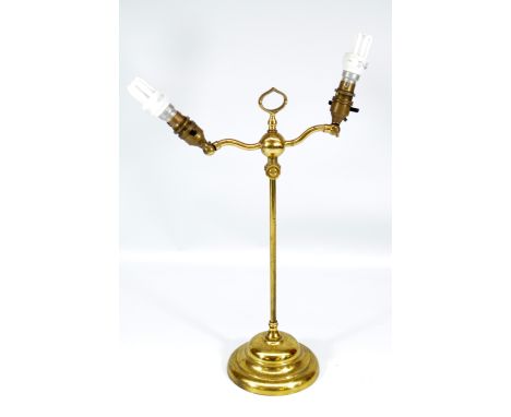 An early 20th century brass adjustable two branch table lamp with adjustable central section and weighted circular base, heig