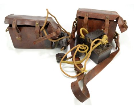 Two WWI period military issue leather cased Morse keys, both with internal 'To Adjust Buzzer' plaques, the first stamped 'B.L