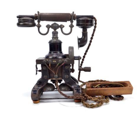 An early 20th century 'Eiffel Tower' skeleton telephone on shaped cast iron base above twin bells, height 29cm. CONDITION REP