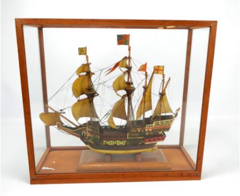 A painted wooden four masted model of an Elizabethan English galleon with nine paper sails, on wooden plinth under glazed dis