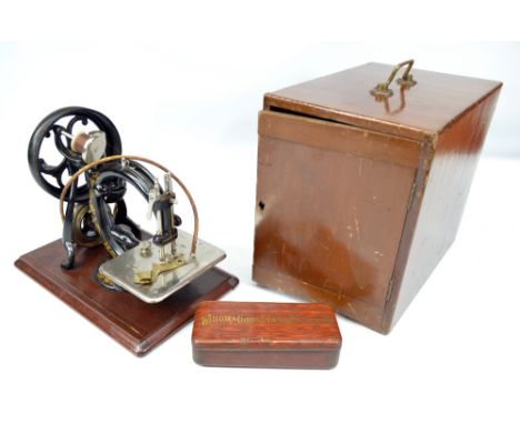WILCOX & GIBBS; a gilt decorated sewing machine in associated case with original accessory tin. CONDITION REPORT: We are unab