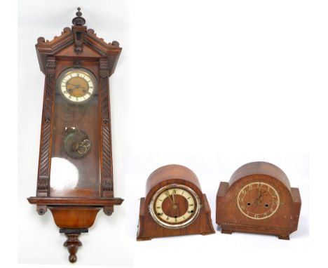 An early 20th century mahogany cased Vienna style wall clock, the enamelled chapter ring set with Roman numerals, the case wi