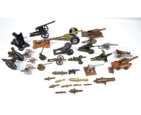 A collection of model cannons to include a green painted example with applied decal reading 'Nulli Secundus British made' and