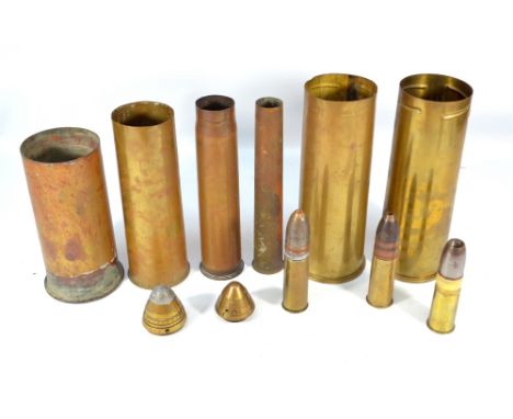 A group of artillery shells, five with broad arrow marks and three with marks Patronem Fabrik Karlsrhue with further stamps 1