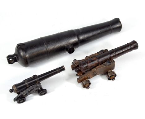Three model signal cannons, one large and heavy iron example, length 38cm, and two smaller examples both with stands (3).