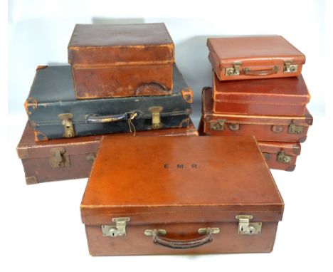 A group of eight vintage leather suitcases of various sizes, one with gilt tooled initials 'R.R.R.' (8). CONDITION REPORT: Ca