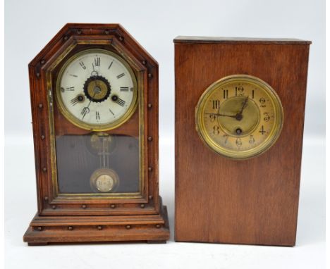 A late 19th century American walnut mantel clock with Roman numerals to the circular dial, height 32cm and a simple home-made