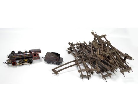 An early 20th century Bing O gauge tinplate loco, no.0-35, with clockwork mechanism and light bulb to front, painted in black