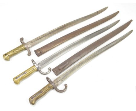 A late 19th century French Chassepot bayonet, the blade back inscribed 'St Etienne Fevrier 1872' with ribbed brass handle and