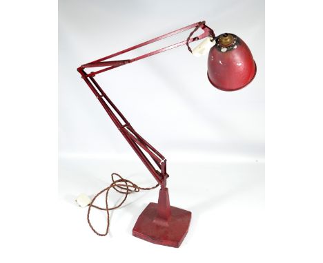 An original mid-20th century red painted adjustable table lamp with weighted rounded square sectioned base.