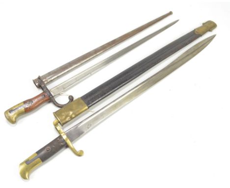 A late 19th century French bayonet, the blade back inscribed 'Mre D'Ormes de St Etienne Aout 1878' with wooden and brass hand