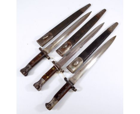 Three wooden handled and steel mounted bayonets, each with broad arrow and War Department stamps, complete with leather scabb