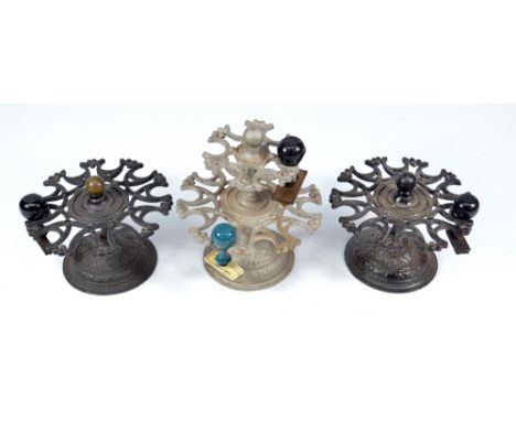 A vintage two tiered cast iron office stamp holder and two similar single tiered examples (3).