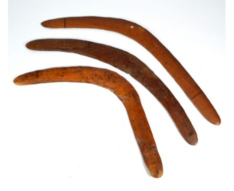 Three late 19th century Australian Aboriginal boomerangs, one with traces of painted dot decoration, length 64cm, 59.5cm and 