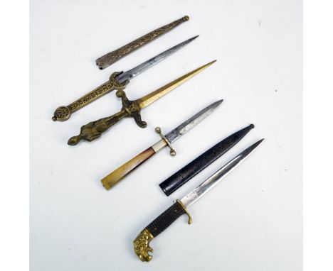 A small knife with lion head pommel, checkered grip, shaped blade and metal scabbard inscribed 'Souvenir from Düren', length 