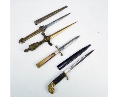 A small knife with lion head pommel, checkered grip, shaped blade and metal scabbard inscribed 'Souvenir from Düren', length 