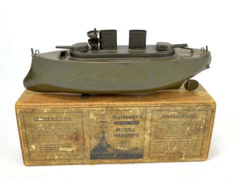 A boxed Sutcliffe tinplate steam driven model warship in dark green, with indistinct manufacturer's stamp to rear, length app